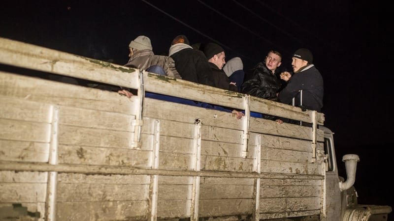 Prisoners of war are loaded onto a truck by pro-Russian rebels for transport to a prisoner exchange near Zholobov