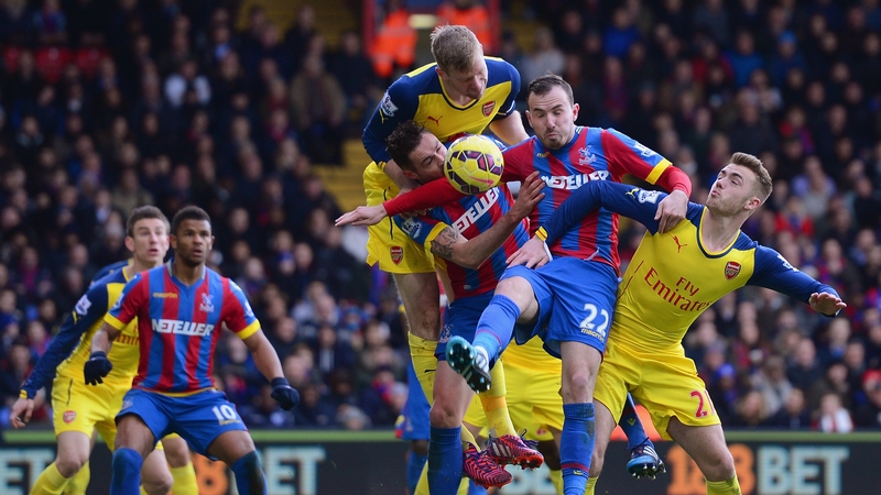 Per Mertesacker of Arsenal, Damien Delaney and Jordon Mutch of Crystal Palace, and Calum Chambers of Arsenal battle for the ball