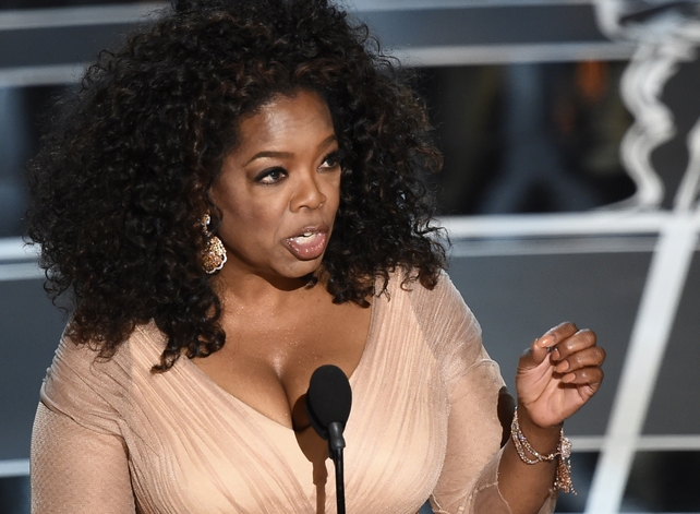 Oprah Winfrey speaking on stage at the awards