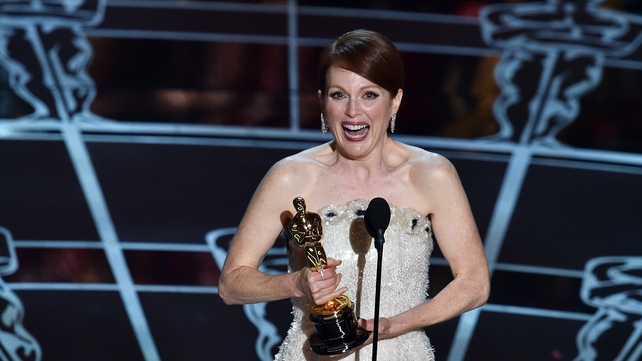 Julianne Moore with the Oscar for best actress, which she won for her role in Still Alice