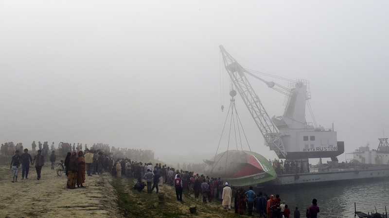 A salvage vessel fitted with a crane raised the sunken ferry from the water