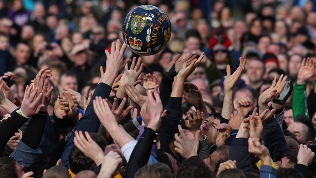 Rival teams the 'Up'ards and Down'ards' battle for the ball during the annual Ashbourne Shrovetide 'no rules' football match in Ashbourne, England
