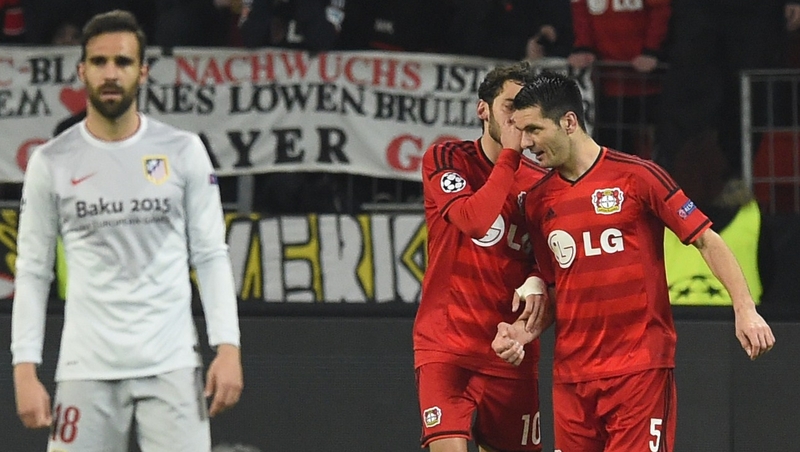 Leverkusen's midfielder Hakan Calhanoglu chats with his team mate Bosnian defender Emir Spahic after scoring
