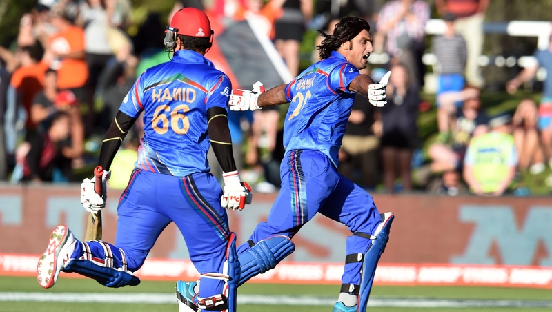 Afghanistan batsman Shapoor Zadran (R) celebrates with team-mate Hamid Hassan (L)