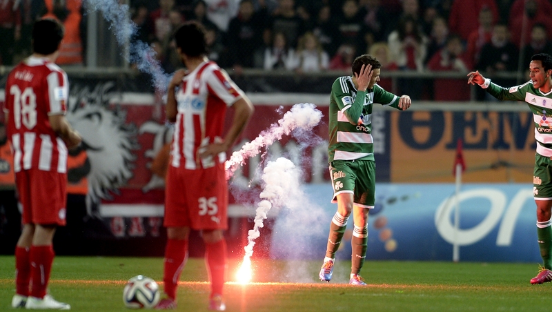 A flare thrown by Olympiakos supporters hits Panathinaikos' Marcus Berg earlier this month