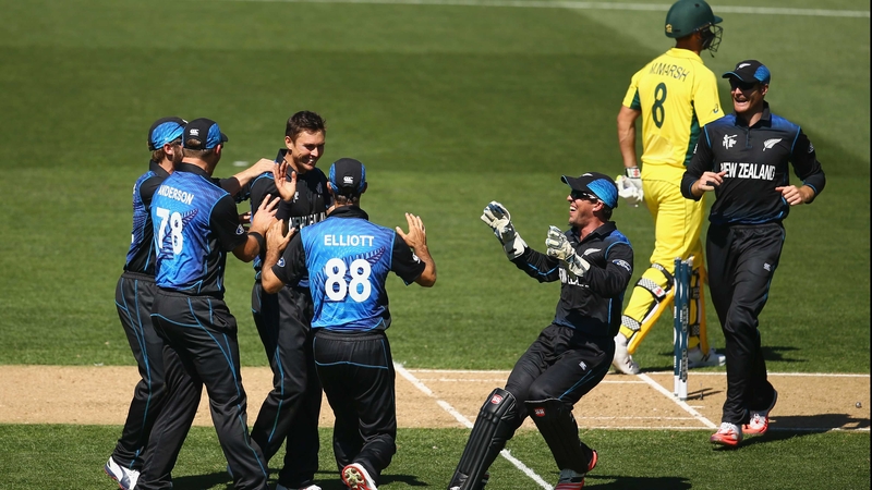 Trent Boult is mobbed by his New Zealand team-mates after dismissing Mitch Marsh