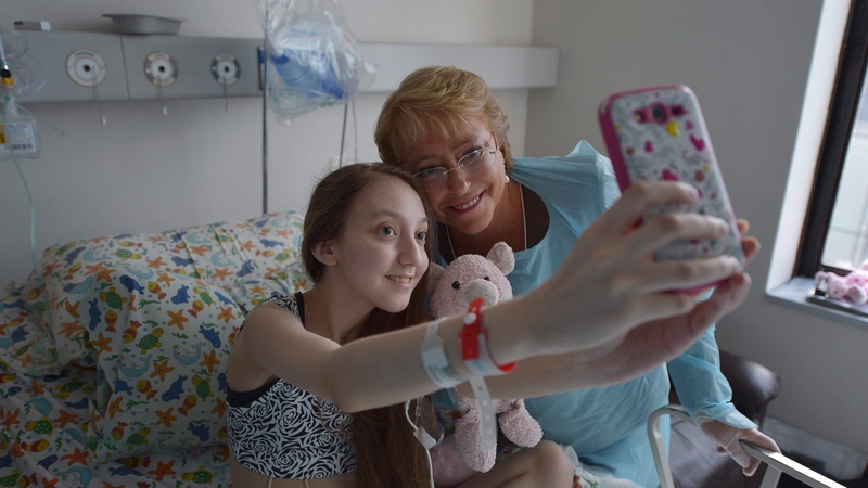 Valentina Maureira and Chile's President Michelle Bachelet take a selfie