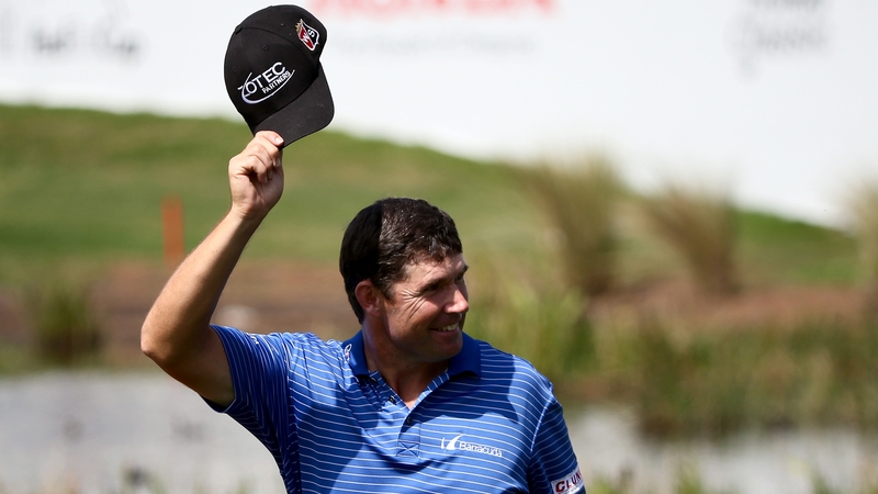 Padraig Harrington tips his hat to the crowd as he walks to the green on the second play-off hole during the continuation of the fourth round of The Honda Classic