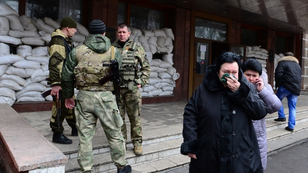 Relatives of miners leave the main entrance of the Zasyadko mine