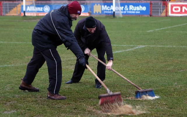 Ground staff removing surface water from the pitch before the Tyrone v Derry game