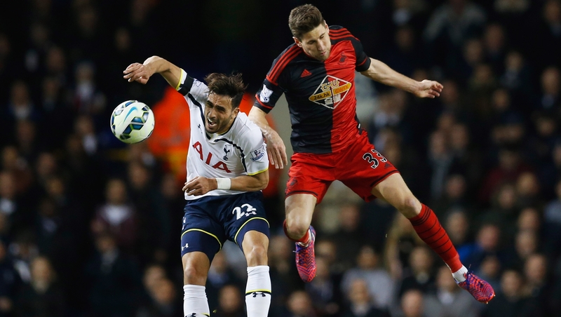 Federico Fernandez of Swansea and Tottenham's Nacer Chadli contest a high ball