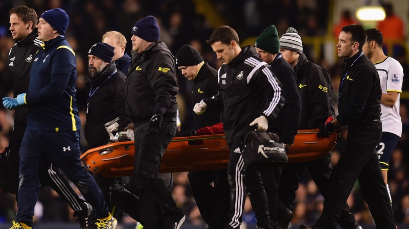 Bafetimbi Gomis of Swansea City was stretchered off during against Tottenham Hotspur