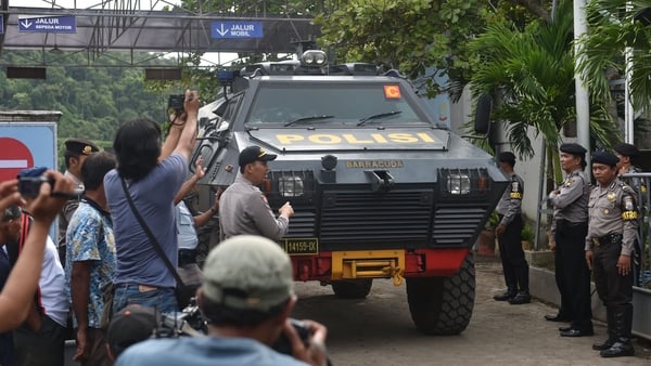 Indonesian police armoured vehicles carrying the Australians leaves the maximum security prison in Nusa Kambangan