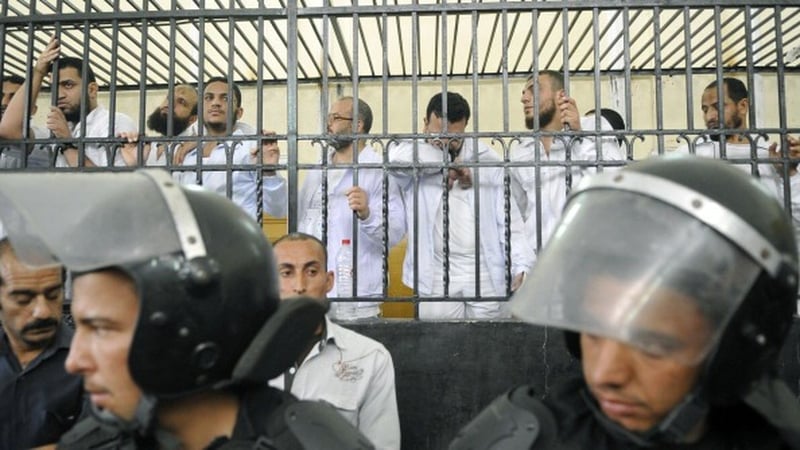 Defendant's react from behind bars during their trial over the violence