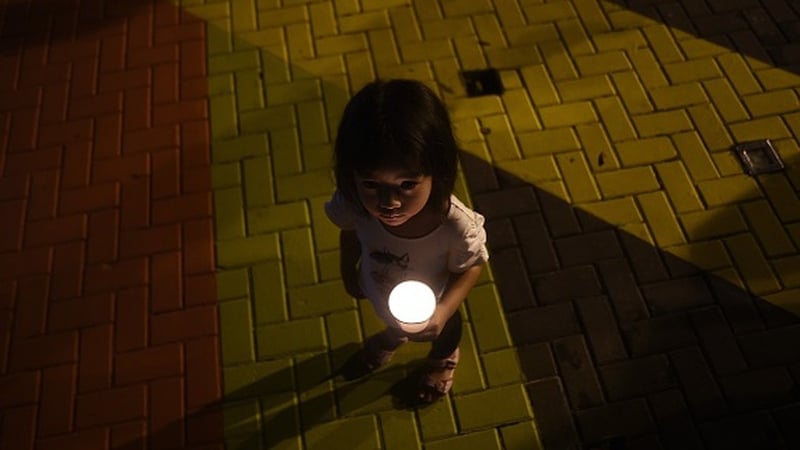 A young girl during a gathering to mark the one-year anniversary of the disappearance of the plane