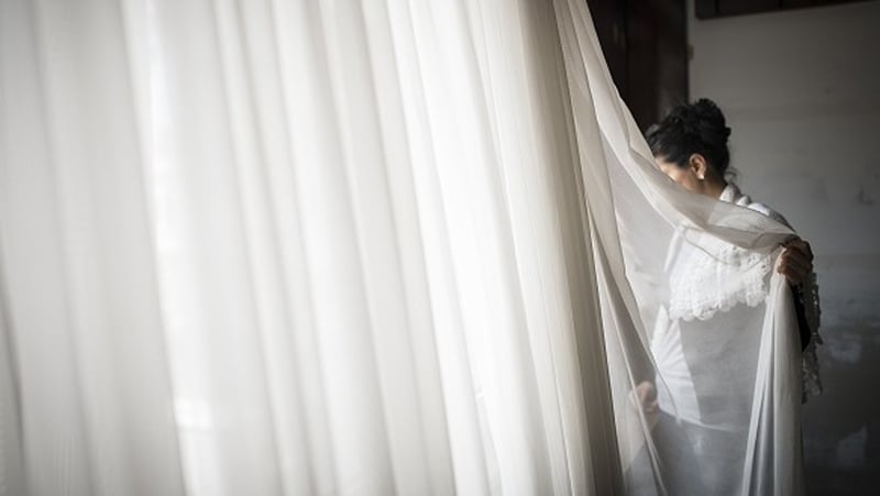 A woman looks out of window at a women's shelter on International Women's Day in Ankara, Turkey