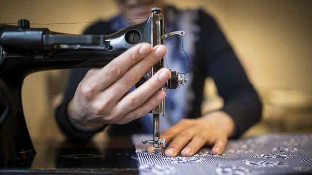 A woman sews a fabric at a women's shelter in Ankara, Turkey