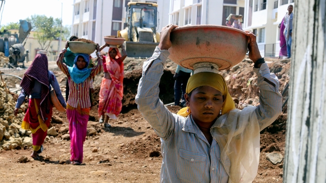 Women work on a construction site in Bhopal, India