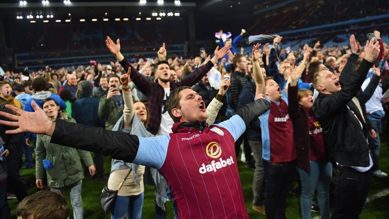 Aston Villa fans celebrate victory on the pitch