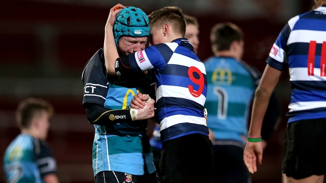 Crescent College’s Mark Edwards consoles Castletroy College's captain Conor Bermingham after the Munster Junior Cup semi-final on Tuesday