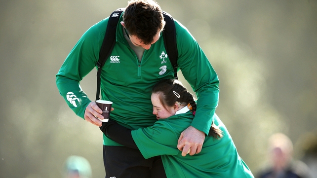Irish fan Jennifer Malone from Clane, Co Kildare hugs Peter O'Mahony before training on Tuesday