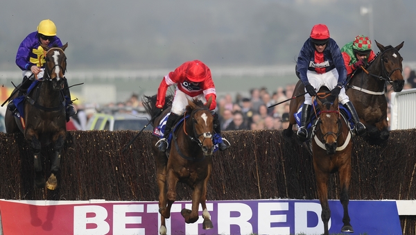 Davy Russell riding Lord Windermere (L) clears the last en route to winning the 2014 Gold Cup