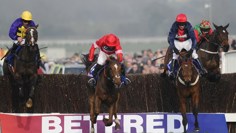 Davy Russell riding Lord Windermere (L) clears the last en route to winning the 2014 Gold Cup
