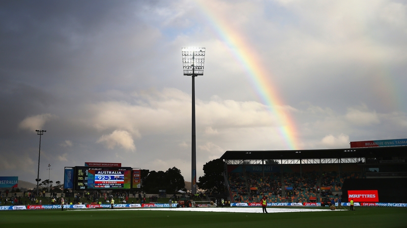 A rainbow appears over the ground during a rain delay during the match