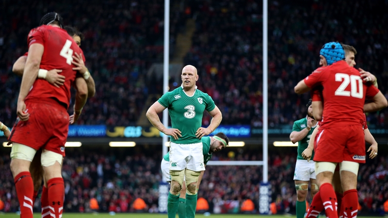 Ireland captain Paul O’Connell cuts a dejected figure as Wales players celebrate their 23-16 victory at the Millennium Stadium