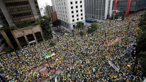 Dressed in the yellow and green of Brazil's flag, many protesters demanded the impeachment of Ms Rousseff