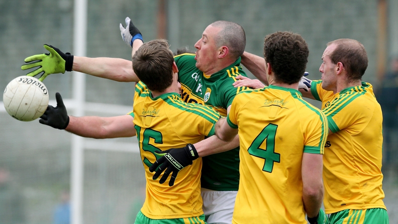 Kerry's Kieran Donaghy uses his second right arm to battle for the ball under pressure from the Donegal defence