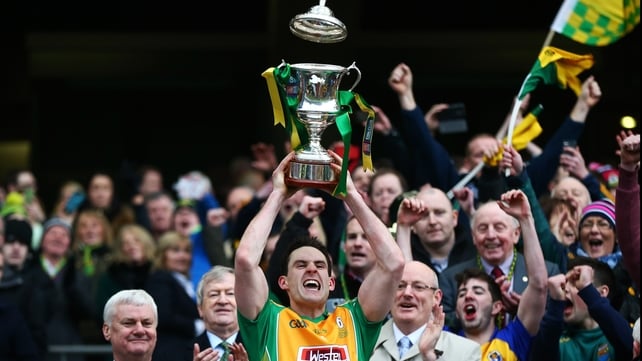 Captain Michael Farragher holds the trophy aloft