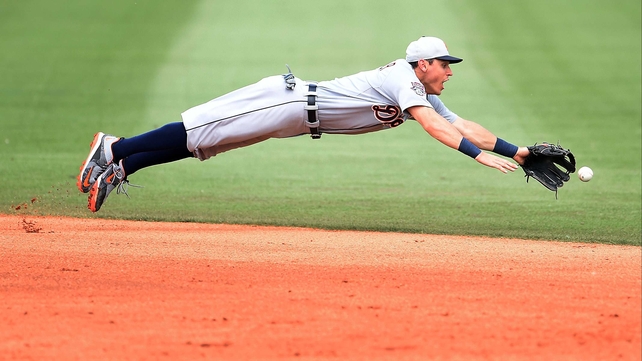 Ian Kinsler of the Detrout Tigers lunges acrobatically for a ground ball during the fifth inning of a spring training game against the Houston Astros at Osceola County Stadium in Florida