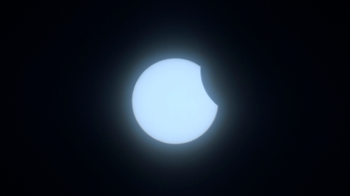 The moon begins to obstruct the sun as the eclipse gets under way
