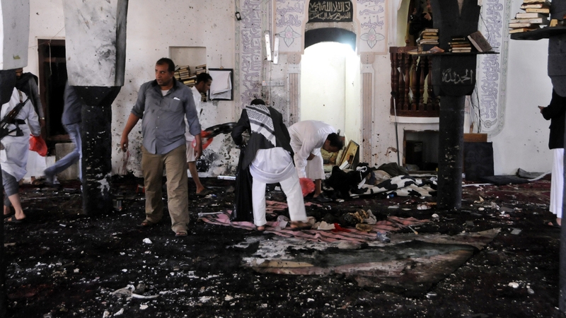 Members of Houthi militia inspect the scene at the al-Hashahush mosque