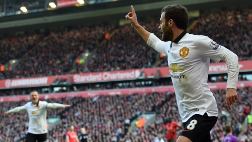 Manchester United's Spanish midfielder Juan Mata (R) celebrates after scoring his first goal