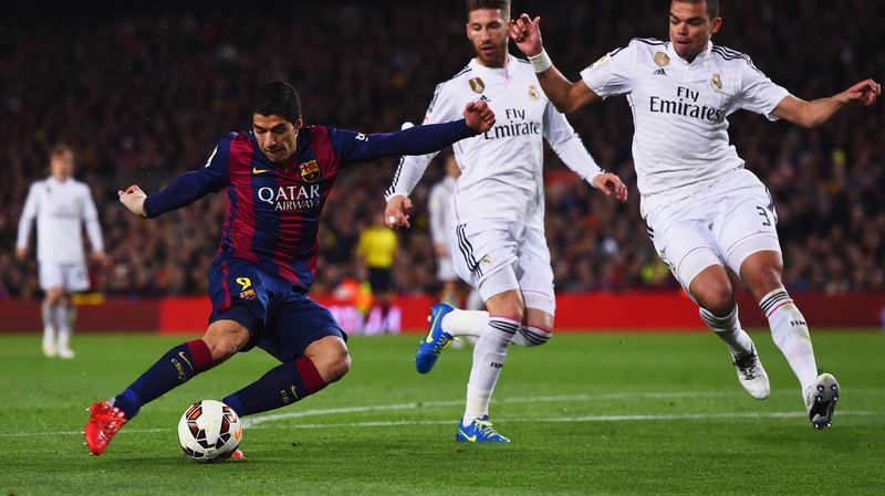 Luis Suarez shoots past Sergio Ramos and Pepe to score Barca's second goal against Real