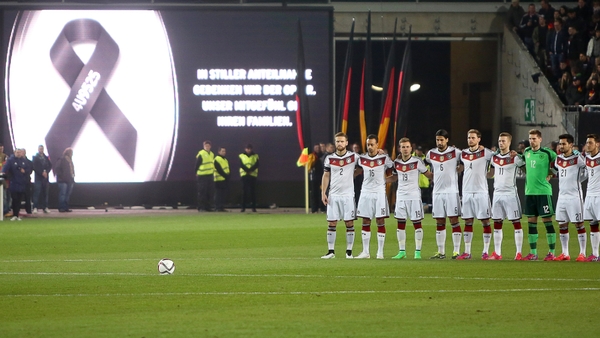 German national soccer team players observe a minute of silence for the victims of the Flight 4U 9525
