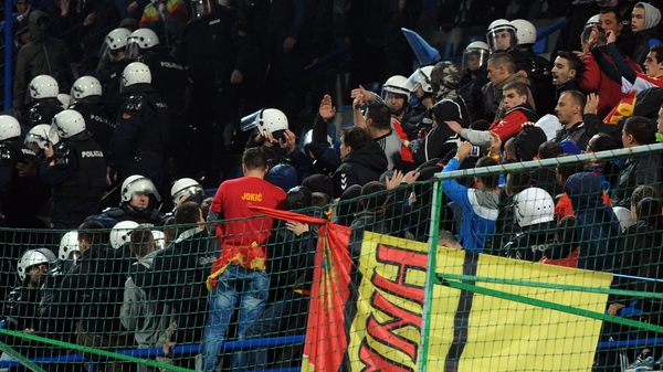 Riot police scuffle with Montenegro supporters during the Euro 2016 qualifier between Montenegro and Russia