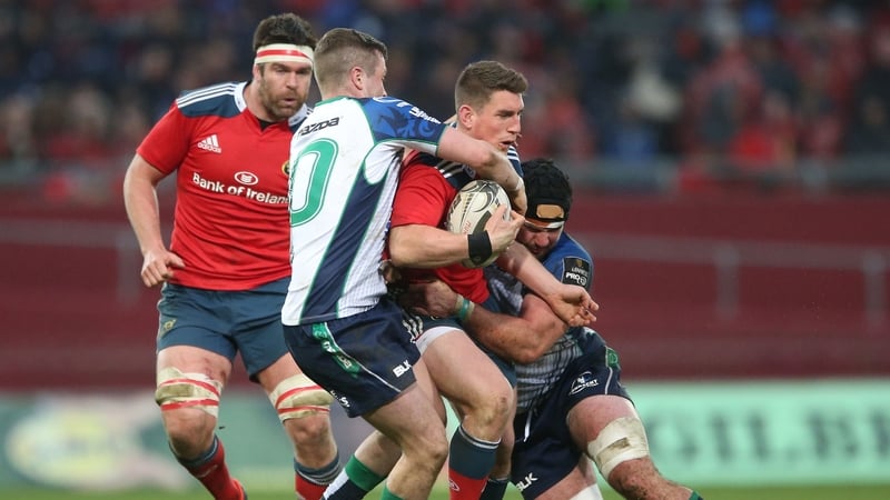 Munster out-half Ian Keatley (carrying ball) got the better of his opposite number Jack Carty (tackling left)