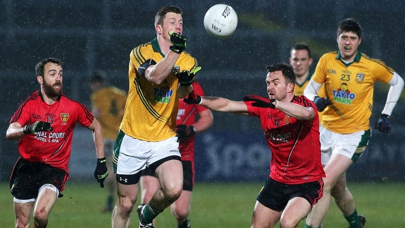 Meath's Kevin Reilly vies for possession with Down's Conor Laverty and Mark Poland