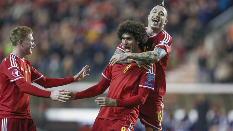 Marouane Fellaini is congratulated by Kevin De Bruyne (L) and Radja Nainggolan after scoring for Belgium in their 5-0 win over Cyprus in Brussels