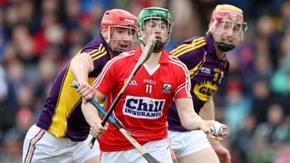 Wexford’s Daithi Waters and Eoin Conroy battle Seamus Harnedy of Cork