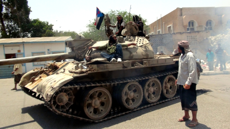 Tribal militants loyal to Yemeni President Abed Rabbo Mansour Hadi ride a tank during clashes with Houthi fighters