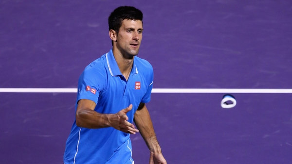 Novak Djokovic throws his wristbands to the crowd after his straight sets victory against John Isner