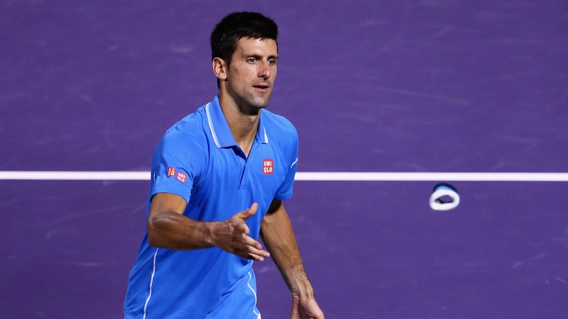 Novak Djokovic throws his wristbands to the crowd after his straight sets victory against John Isner