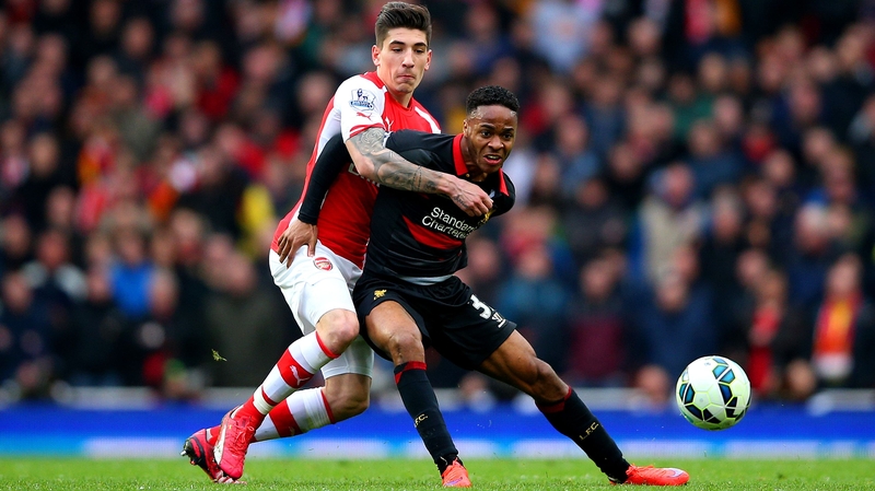 Raheem Sterling of Liverpool battles for the ball with Hector Bellerin of Arsenal