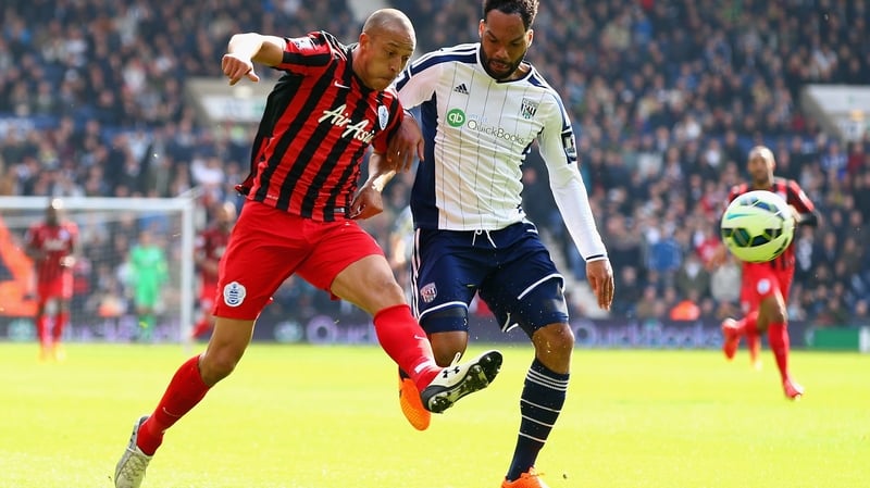 Bobby Zamora of QPR scores their third goal under pressure from West Brom's Joleon Lescott