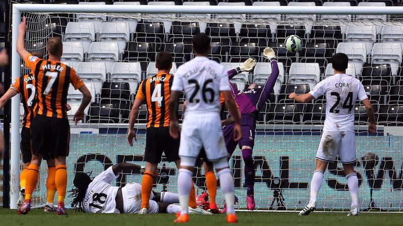 Swansea City's French striker Bafetimbi Gomis (no. 18) scores the Swans' second goal