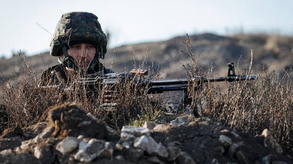A Ukrainian soldier takes position at the front line near the town Kurahovo, not far from Donetsk